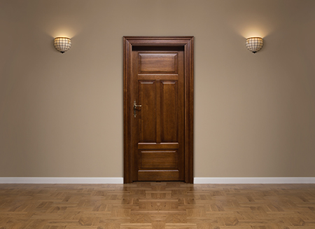 a classic mahogany hardwood door on a classy dark beige wall